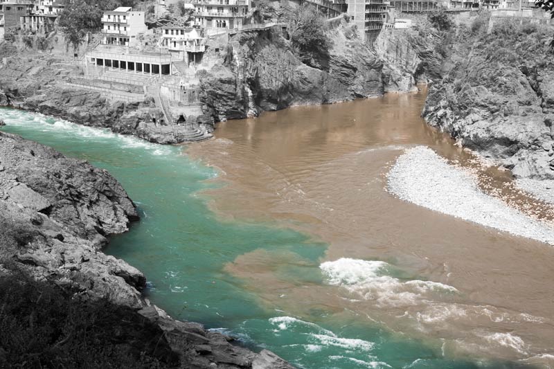Muddy water of river Alakananda meeting  clear bluish-green water of Bhagirathi at their confluence in Devaprayag, district Tehri-Garhwal, Uttarakhand